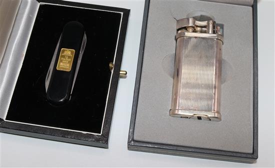 Swiss black enamelled penknife inset 1gr 24K gold bar and a Dunhill Unique cigarette lighter, cased